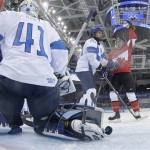 Jayna Hefford of Canada celebrates her goal as the puck rolls back out of the net past Goalkeeper Noora Raty of Finland during the third period of the 2014 Winter Olympics women's ice hockey game at Shayba Arena, Monday, Feb. 10, 2014, in Sochi, Russia. Canada defeated Finland 3-0.(AP Photo/Matt Slocum, Pool)