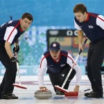 Team USA's skip John Shuster, center, releases the rock to his sweepers John Landsteiner, left, and Jared Zezel during men's curling competition against Norway at the 2014 Winter Olympics, Monday, Feb. 10, 2014, in Sochi, Russia. (AP Photo/Robert F. Bukaty)
