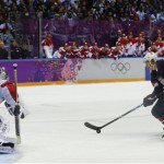USA forward T.J. Oshie prepares to take a shot against Russia goaltender Sergei Bobrovski in an overtime shootout during a men's ice hockey game at the 2014 Winter Olympics, Saturday, Feb. 15, 2014, in Sochi, Russia. Oshie scored the winning goal and the USA won 3-2. (AP Photo/Julio Cortez)