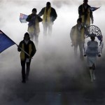 Peter Crooks of the British Virgin Islands holds his country's national flag and enters with his team during the opening ceremony of the 2014 Winter Olympics in Sochi, Russia, Friday, Feb. 7, 2014. (AP Photo/Charlie Riedel)