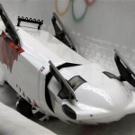 The team from Canada CAN-3, with Justin Kripps, Jesse Lumsden, Cody Sorensen and Ben Coakwell, slide down the track upside down after crashing in turn sixteen during the men's four-man bobsled competition at the 2014 Winter Olympics, Saturday, Feb. 22, 2014, in Krasnaya Polyana, Russia. (AP Photo/Dita Alangkara)