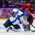Finland forward Jori Lehtera fights Canada forward John Tavares for the puck in the third period of a men's ice hockey game at the 2014 Winter Olympics, Sunday, Feb. 16, 2014, in Sochi, Russia. (AP Photo/Mark Humphrey)