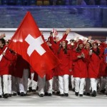 Simon Ammann of Switzerland carries the national flag as he leads the team during the opening ceremony of the 2014 Winter Olympics in Sochi, Russia, Friday, Feb. 7, 2014. (AP Photo/Mark Humphrey)