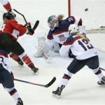 Marie-Philip Poulin of Canada (29) scores a goal against USA goalkeeper Jessie Vetter (31) during the third period of the women's gold medal ice hockey game at the 2014 Winter Olympics, Thursday, Feb. 20, 2014, in Sochi, Russia. (AP Photo/Julio Cortez)