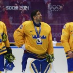 From left, Sweden defenseman Johnny Oduya, goaltender Henrik Lundqvist and forward Gustav Nyqvist react after receiving their silver medals after losing 3-0 to Canada in the men's gold medal ice hockey game at the 2014 Winter Olympics, Sunday, Feb. 23, 2014, in Sochi, Russia. (AP Photo/Julio Cortez)