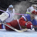 Slovenia goaltender Robert Kristan reaches over Russia forward Alexei Tereshenko as they fall to the ice at the goal in the first period of a men's ice hockey game at the 2014 Winter Olympics, Thursday, Feb. 13, 2014, in Sochi, Russia. Russia won 5-2. (AP Photo/Bruce Bennett, Pool)