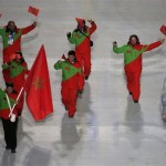 Adam Lamhamedi of Morocco holds his national flag and enters the arena with teammates during the opening ceremony of the 2014 Winter Olympics in Sochi, Russia, Friday, Feb. 7, 2014. (AP Photo/Charlie Riedel)