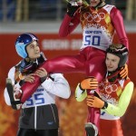 Poland's Kamil Stoch, center, is carried by his teammates Jan Ziobro, right, and Maciej Kot, left, after winning the gold in the men's normal hill ski jumping final at the 2014 Winter Olympics, Sunday, Feb. 9, 2014, in Krasnaya Polyana, Russia.(AP Photo/Gregorio Borgia)