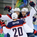 USA forward Zach Parise (9) celebrates his goal against the Czech Republic with teammates Phil Kessel (81) and USA defenseman Ryan Suter during the second period of men's quarterfinal hockey game in Shayba Arena at the 2014 Winter Olympics, Wednesday, Feb. 19, 2014, in Sochi, Russia. (AP Photo/Matt Slocum)