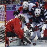 USA forward Zach Parise (9) tries to score against Canada goaltender Carey Price during the first period of a men's semifinal ice hockey game at the 2014 Winter Olympics, Friday, Feb. 21, 2014, in Sochi, Russia. (AP Photo/Julio Cortez)