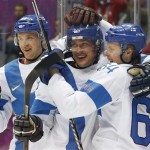 Finland forward Teemu Selanne, center, celebrates with teammates forward Lauri Korpikoski, left, and forward Mikael Grandlund after scoring a goal against the USA during the second period of the men's bronze medal ice hockey game at the 2014 Winter Olympics, Saturday, Feb. 22, 2014, in Sochi, Russia. (AP Photo/Mark Humphrey)