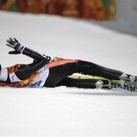 Switzerland's Simon Ammann sits in the snow after his second attempt during the men's normal hill ski jumping final at the 2014 Winter Olympics, Sunday, Feb. 9, 2014, in Krasnaya Polyana, Russia. (AP Photo/Gregorio Borgia)