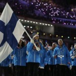 Enni Rukajarvi of Finland carries the national flag as she leads her team into the stadium during the opening ceremony of the 2014 Winter Olympics in Sochi, Russia, Friday, Feb. 7, 2014. (AP Photo/Matt Dunham)