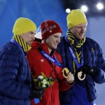 Medal winners in the men's cross-country 15K classical race, from left, Sweden's Johan Olsson, silver, Switzerland's Dario Cologna, gold, and Sweden's Daniel Richardsson, bronze, pose with their medals at the 2014 Winter Olympics in Sochi, Russia, Friday, Feb. 14, 2014. (AP Photo/David J. Phillip )