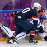 Ryan Suter of the United States and Lauri Korpikoski of Finland collide against the wall during the second period of the men's bronze medal ice hockey game at the 2014 Winter Olympics, Saturday, Feb. 22, 2014, in Sochi, Russia. (AP Photo/Matt Slocum)