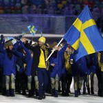 Anders Soedergren of Sweden carries the national flag as he leads the team during the opening ceremony of the 2014 Winter Olympics in Sochi, Russia, Friday, Feb. 7, 2014. (AP Photo/Mark Humphrey)