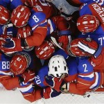 Members of Team Russia hug after defeating Japan 6-3 during the 2014 Winter Olympics women's ice hockey game at Shayba Arena Sunday, Feb. 16, 2014, in Sochi, Russia. (AP Photo/Matt Slocum)