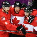 Canada forward Benn Jamie, center, celebrates his goal against the USA with teammates Jay Bouwmeester, left, and Corey Perry, right, during the second period of the men's semifinal ice hockey game at the 2014 Winter Olympics, Friday, Feb. 21, 2014, in Sochi, Russia. (AP Photo/Mark Humphrey)