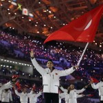 Alper Ucar of Turkey waves the national flag as he leads his team into the stadium during the opening ceremony of the 2014 Winter Olympics in Sochi, Russia, Friday, Feb. 7, 2014. (AP Photo/Matt Dunham)