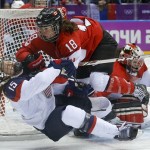 Catherine Ward of Canada (18) shoves Anne Schleper of the United States (15) to the ice during overtime of the women's gold medal ice hockey game at the 2014 Winter Olympics, Thursday, Feb. 20, 2014, in Sochi, Russia. (AP Photo/Matt Slocum)