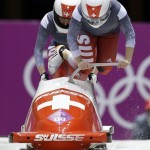 The team from Switzerland SUI-1, piloted Fabienne Meyer with brakeman Tanja Mayer, start their third run during the women's bobsled competition at the 2014 Winter Olympics, Wednesday, Feb. 19, 2014, in Krasnaya Polyana, Russia. (AP Photo/Natacha Pisarenko)