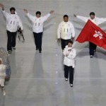 Lui Pan To Barton of Hong Kong waves his national flag and enters the arena with teammates during the opening ceremony of the 2014 Winter Olympics in Sochi, Russia, Friday, Feb. 7, 2014. (AP Photo/Charlie Riedel)