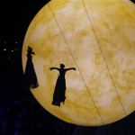 The shadow of artists fall on a giant balloon meant to represent the moon during the closing ceremony of the 2014 Winter Olympics, Sunday, Feb. 23, 2014, in Sochi, Russia. (AP Photo/Dmitry Lovetsky)