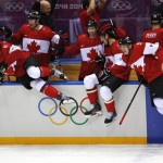 The Canadian bench jumps out of the bench area to celebrate their 3-0 win over Sweden in the men's gold medal ice hockey game at the 2014 Winter Olympics, Sunday, Feb. 23, 2014, in Sochi, Russia. (AP Photo/Petr David Josek)