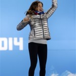 Women's super combined bronze medalist Julia Mancuso of the United States jumps on the podium during the medals ceremony at the 2014 Winter Olympics, Monday, Feb. 10, 2014, in Sochi, Russia.(AP Photo/Morry Gash)