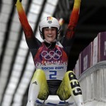 Natalie Geisenberger of Germany smiles to after finishing her final run to win the gold medal during the women's singles luge competition at the 2014 Winter Olympics, Tuesday, Feb. 11, 2014, in Krasnaya Polyana, Russia. (AP Photo/Dita Alangkara)