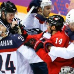 USA forward Ryan Callahan and Canada forward Chris Kunitz mix it up during the first period of the men's semifinal ice hockey game at the 2014 Winter Olympics, Friday, Feb. 21, 2014, in Sochi, Russia. (AP Photo/Matt Slocum)