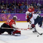 Canada goaltender Carey Price blocks a shot by USA forward Zach Parise during the second period of a men's semifinal ice hockey game at the 2014 Winter Olympics, Friday, Feb. 21, 2014, in Sochi, Russia. (AP Photo/Petr David Josek)
