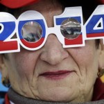 A skating fan wears glasses in the colors of the Russian flag as she watches the men's 500-meter speedskating race at the Adler Arena Skating Center during the 2014 Winter Olympics, Monday, Feb. 10, 2014, in Sochi, Russia. (AP Photo/Matt Dunham)