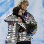 Ice dance figure skating gold medalists Meryl Davis and Charlie White of the United States hug one another during their medals ceremony at the 2014 Winter Olympics, Tuesday, Feb. 18, 2014, in Sochi, Russia. (AP Photo/Morry Gash)