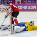 Canada forward Sidney Crosby shoots and scores on Sweden goaltender Henrik Lundqvist during the second period of the men's gold medal ice hockey game at the 2014 Winter Olympics, Sunday, Feb. 23, 2014, in Sochi, Russia. (AP Photo/Julio Cortez)