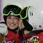 Canada's Justine Dufour-Lapointe, right, celebrates her gold medal in the women's moguls final, with her sister and silver medalist Chloe Dufour-Lapointe, left, at the Rosa Khutor Extreme Park, at the 2014 Winter Olympics, Saturday, Feb. 8, 2014, in Krasnaya Polyana, Russia. (AP Photo/Andy Wong)