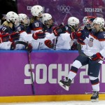 Alex Carpenter of the United States (25) celebrates with teammates after scoring a goal against Canada during the third period of the women's gold medal ice hockey game at the 2014 Winter Olympics, Thursday, Feb. 20, 2014, in Sochi, Russia. (AP Photo/Matt Slocum)