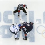 Finland forward Mikael Grandlund and USA forward David Backes face off to start the men's bronze medal ice hockey game at the 2014 Winter Olympics, Saturday, Feb. 22, 2014, in Sochi, Russia. (AP Photo/David J. Phillip )