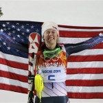 Women's slalom gold medal winner Mikaela Shiffrin of the United States poses for photographers with the American flag at the Sochi 2014 Winter Olympics, Friday, Feb. 21, 2014, in Krasnaya Polyana, Russia.(AP Photo/Christophe Ena)