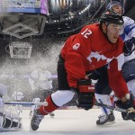 Canada forward Patrick Marleau hits the ice against Finland defenseman Juuso Hietanen in the first period of a men's ice hockey game at the 2014 Winter Olympics, Sunday, Feb. 16, 2014, in Sochi, Russia. (AP Photo/Mark Blinch, Pool)