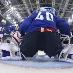 USA forward David Backes, left, fires a goal shot past Slovenia goaltender Luka Gracnar during the third period of a men's ice hockey game at the 2014 Winter Olympics, Sunday, Feb. 16, 2014, in Sochi, Russia. USA defeated Slovenia 5-1. (AP Photo/Martin Rose, Pool)