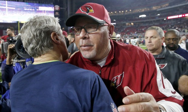 Arizona Cardinals head coach Bruce Arians, right, talks with Seattle Seahawks head coach Pete Carro...