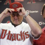  New Arizona Diamondbacks baseball team manager Chip Hale, left, puts on a Diamondbacks hat as he is introduced by chief baseball officer Tony LaRussa during a news conference Monday, Oct. 13, 2014, in Phoenix. The former Diamondbacks third base coach was hired Monday to replace fired Kirk Gibson as the Diamondbacks manager. The 49-year-old managed in Arizona's minor league system for six seasons and was with the Diamondbacks from 2007-09 in the first of eight consecutive seasons as a big league third base coach. (AP Photo/Ross D. Franklin)