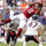 Arizona Cardinals wide receiver Larry Fitzgerald (11) leaps for a pass as Chicago Bears free safety Chris Conte (47) defends during the first half of an NFL football game, Sunday, Dec. 23, 2012, in Glendale, Ariz. (AP Photo/Paul Connors)