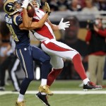 Arizona Cardinals wide receiver Michael Floyd, right, catches a 44-yard pass as St. Louis Rams cornerback Cortland Finnegan defends during the second quarter of an NFL football game on Sunday, Sept. 8, 2013, in St. Louis. (AP Photo/L.G. Patterson)