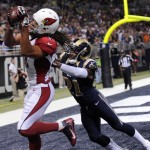 Arizona Cardinals wide receiver Larry Fitzgerald, left, catches a 4-yard pass for a touchdown as St. Louis Rams cornerback Janoris Jenkins defends during the second quarter of an NFL football game on Sunday, Sept. 8, 2013, in St. Louis. (AP Photo/L.G. Patterson)
