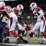 Arizona Cardinals defensive tackle Dan Williams, center, returns an interception for a touchdown as teammates Jasper Brinkley (52) and Karlos Dansby, right, watch during the third quarter of an NFL football game against the St. Louis Rams, Sunday, Sept. 8, 2013, in St. Louis. (AP Photo/Tom Gannam)