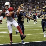 Arizona Cardinals wide receiver Larry Fitzgerald, left, catches a 24-yard pass for a touchdown as St. Louis Rams cornerback Cortland Finnegan and safety Rodney McLeod (23) defend during the third quarter of an NFL football game on Sunday, Sept. 8, 2013, in St. Louis. (AP Photo/L.G. Patterson)