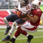 Chicago Bears running back Matt Forte (22) scores a touchdown as Arizona Cardinals free safety Kerry Rhodes (25) defends during the first half of an NFL football game, Sunday, Dec. 23, 2012, in Glendale, Ariz. (AP Photo/Paul Connors)