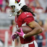 Arizona Cardinals wide receiver Larry Fitzgerald (11) warms up prior to an NFL football game against the Washington Redskins, Sunday, Oct. 12, 2014, in Glendale, Ariz. (AP Photo/Rick Scuteri)